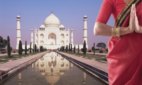 Indian woman in traditional clothing near the Taj Mahal